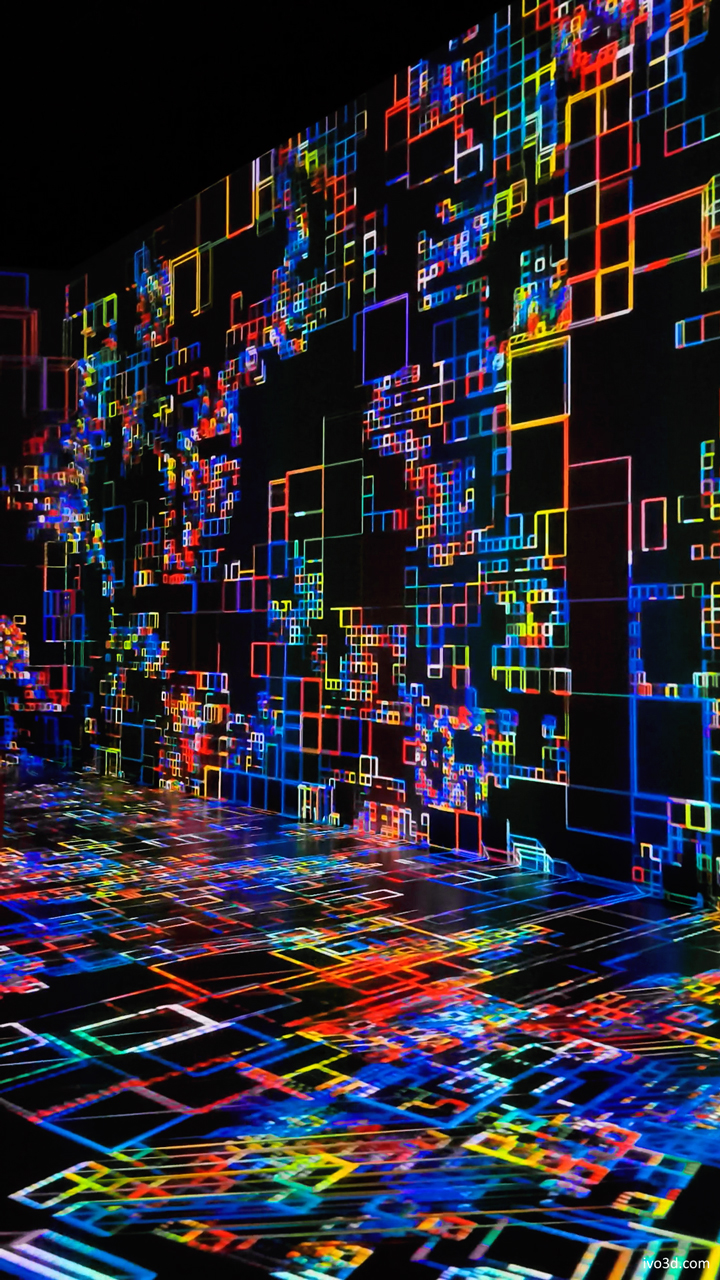 A vibrant display of colorful geometric patterns projected on walls and floor, creating an immersive digital art installation at Code Veszprem.